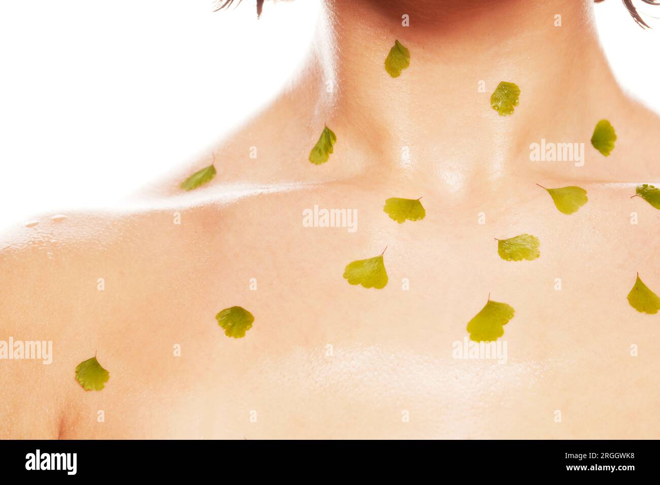 Body paint leaves on young woman's neck Stock Photo