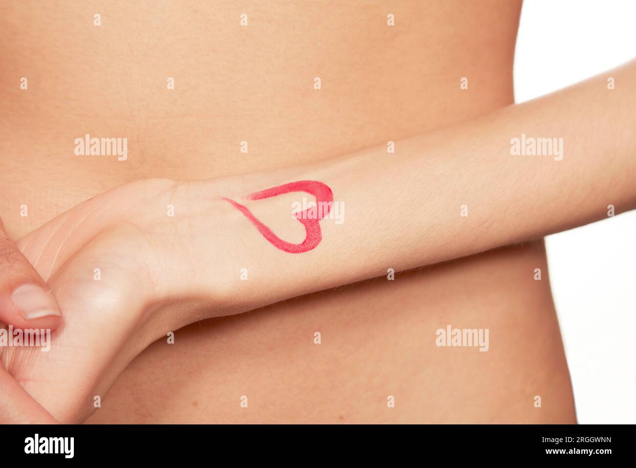 Body paint heart on woman's wrist Stock Photo