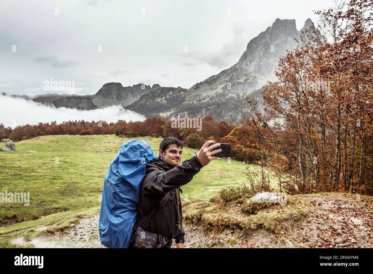 Young man taking selfie while hiking Stock Photo