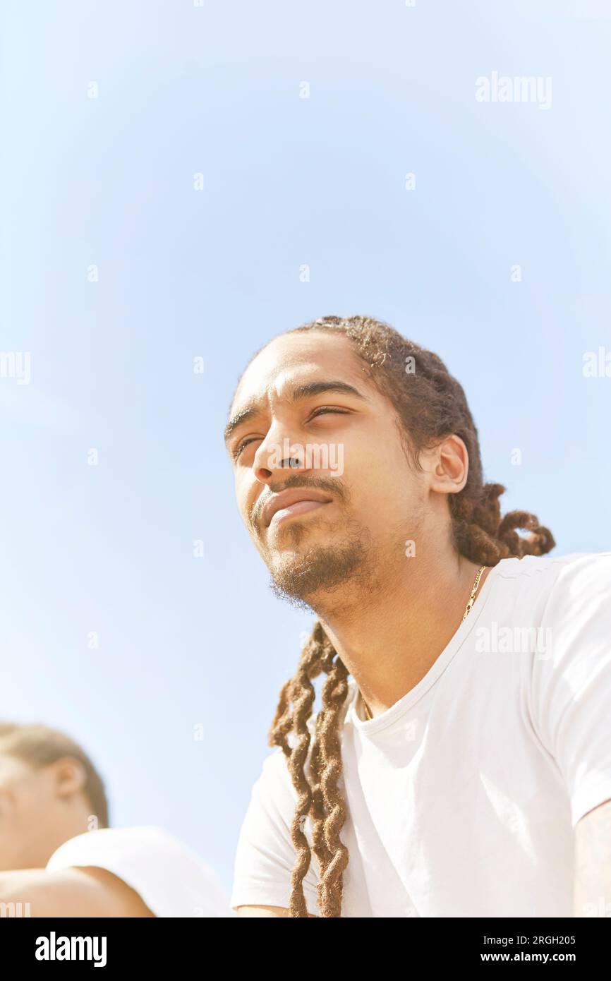 Young man against clear sky Stock Photo