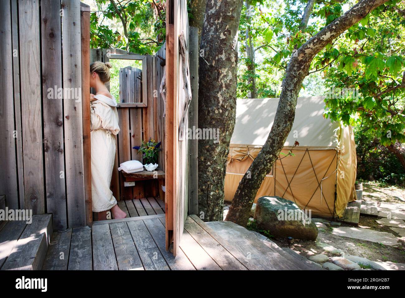 Woman wearing robe in outdoor shower Stock Photo Alamy