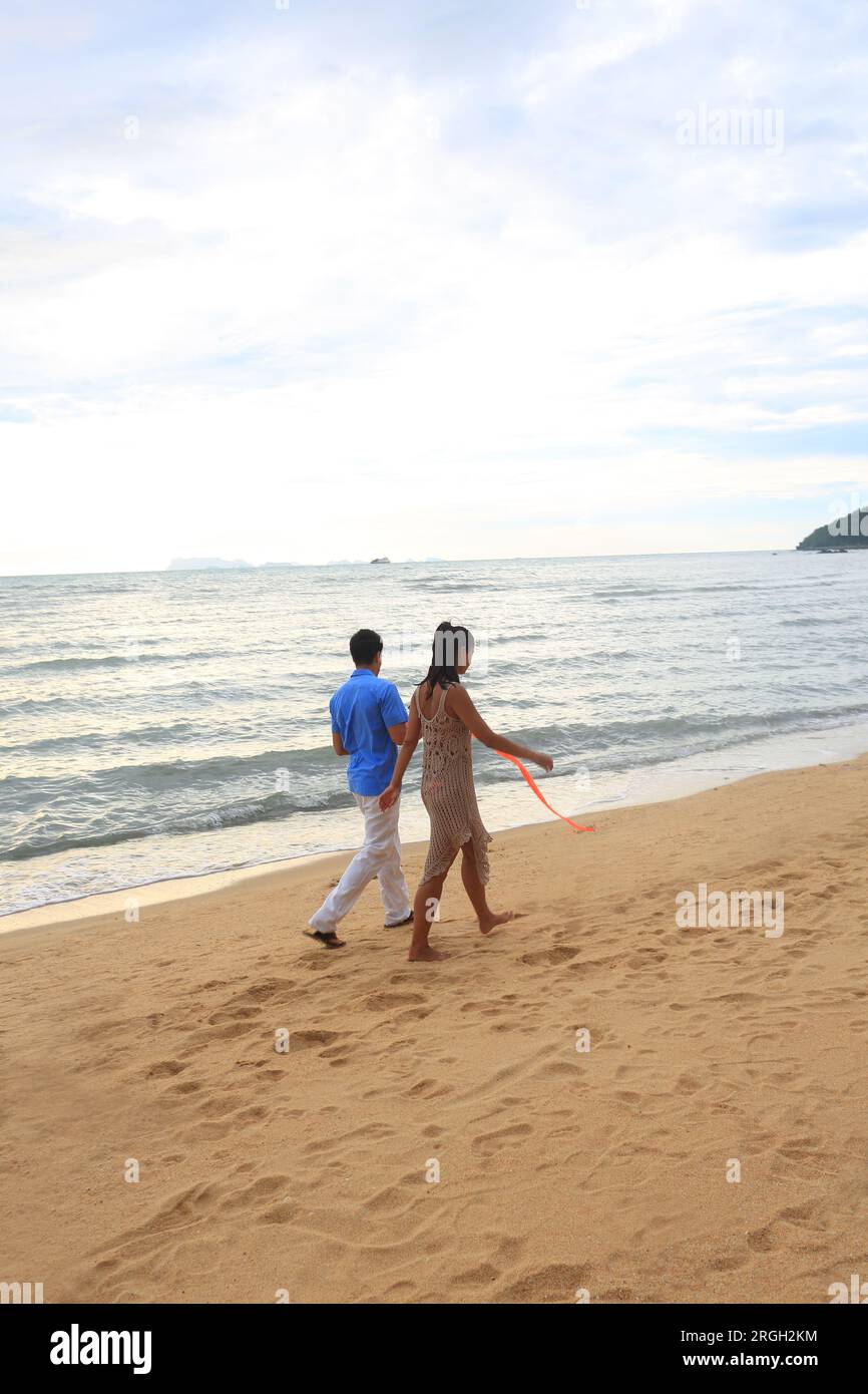 Young couple walking on beach Stock Photo