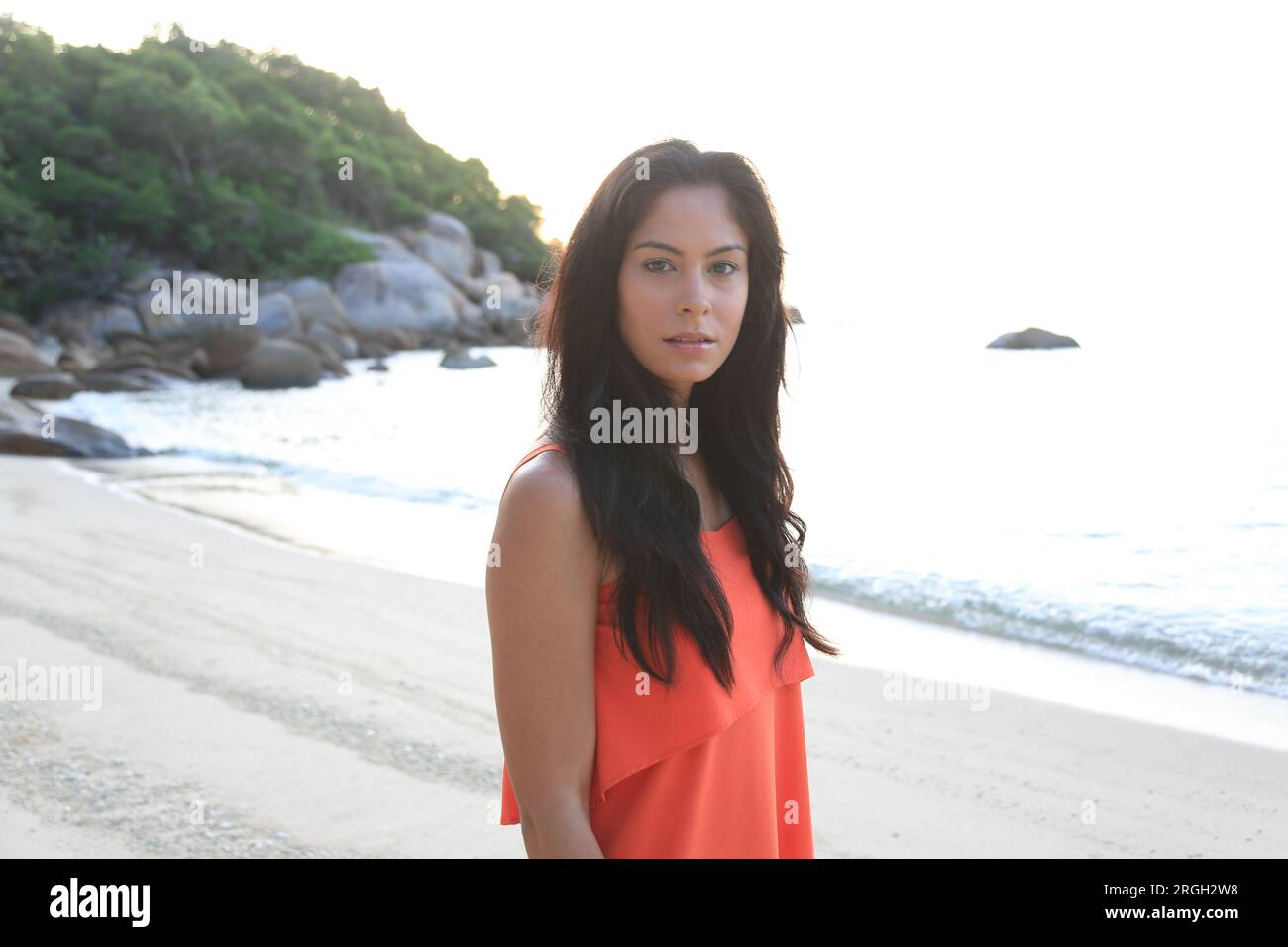 Black haired young woman on beach Stock Photo