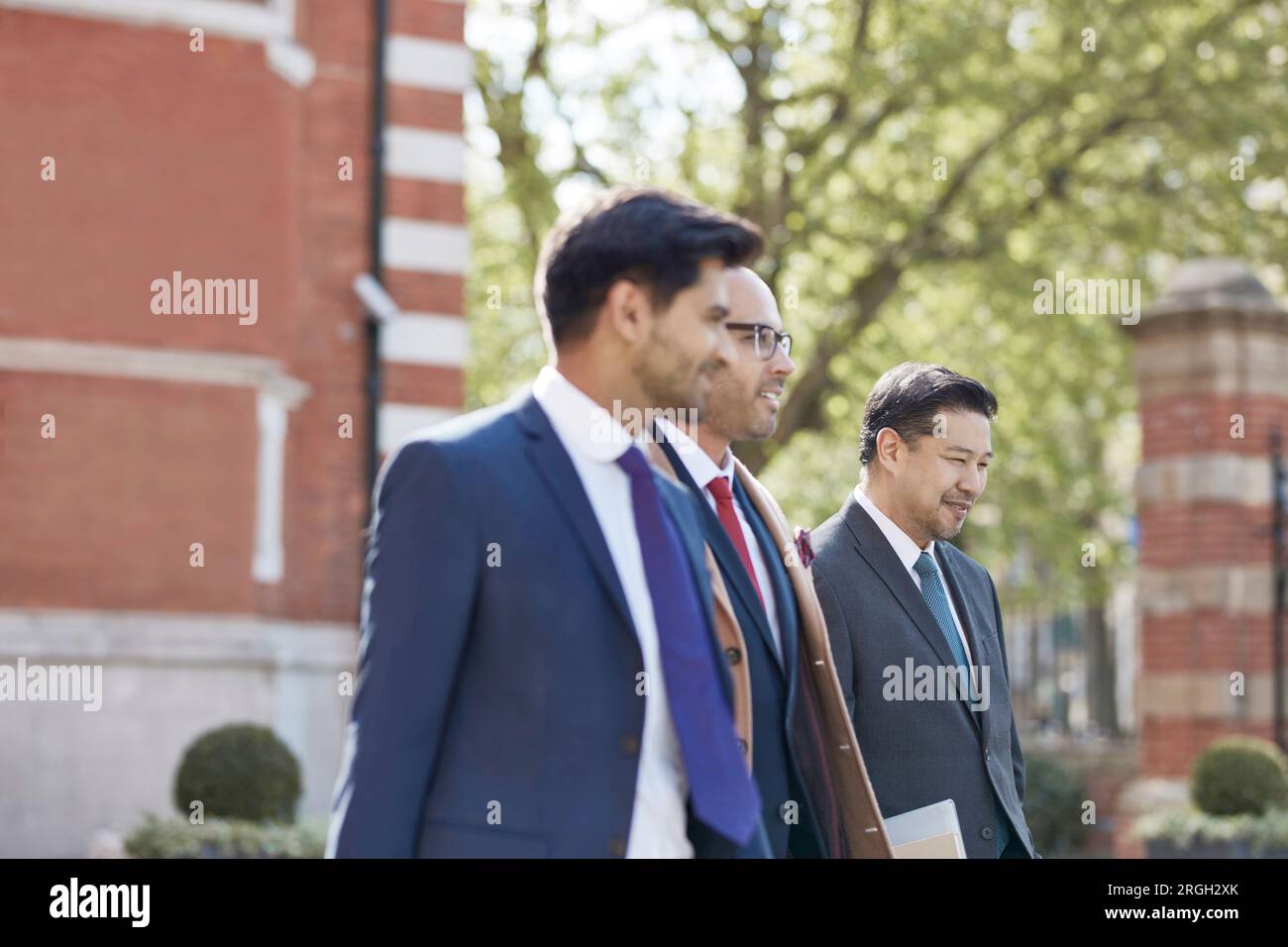 Businessmen walking together Stock Photo - Alamy