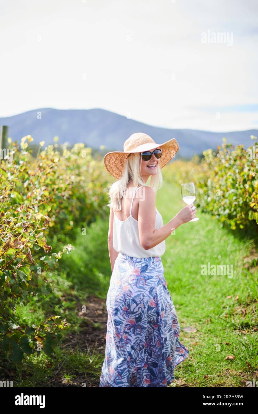 Smiling woman with wineglass at vineyard Stock Photo