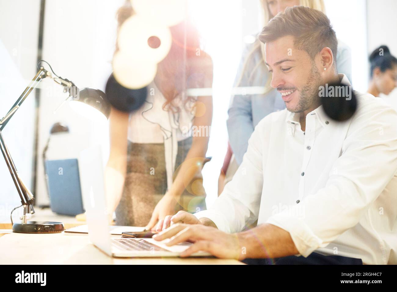 Young businessman using laptop at desk Stock Photo