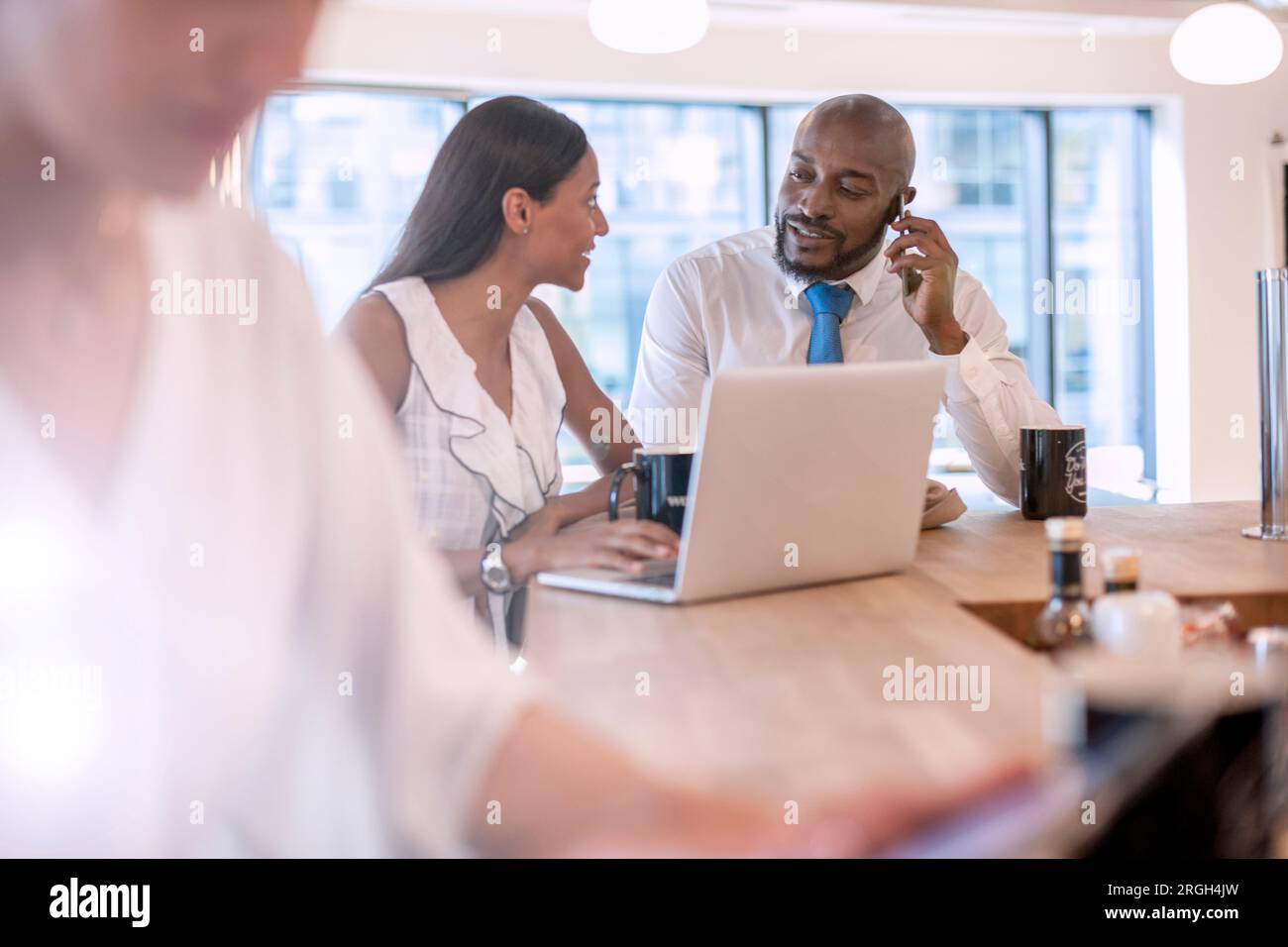 Colleagues using laptop Stock Photo