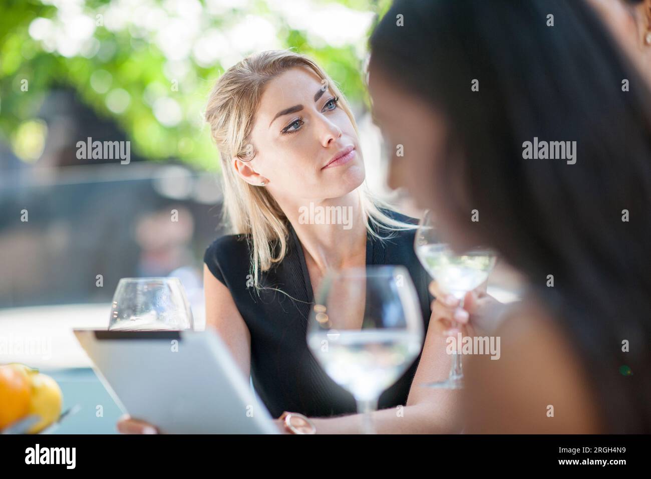 Businesswomen using digital tablet at restaurant Stock Photo