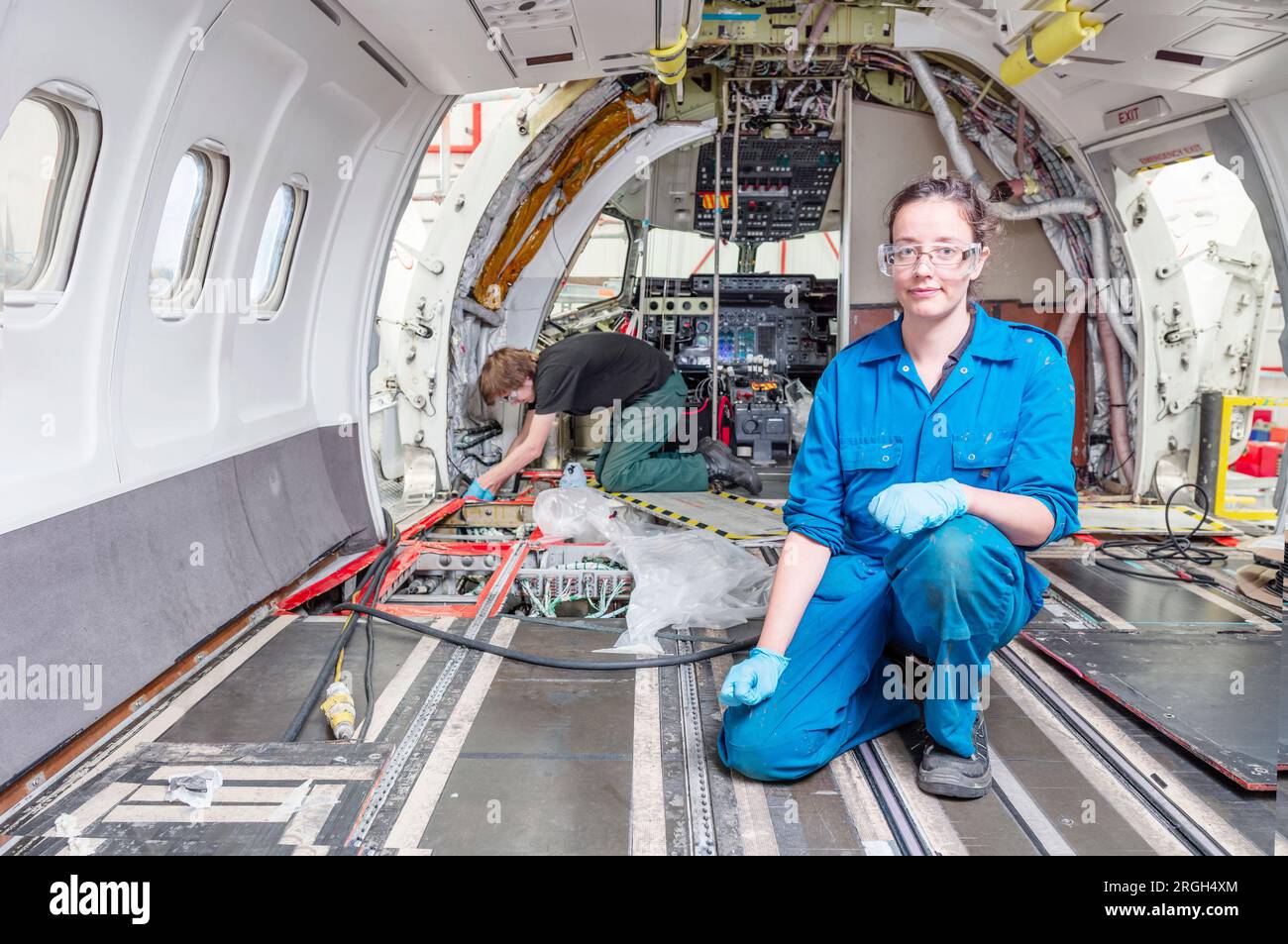 Woman kneeling inside airplane stock photo alamy