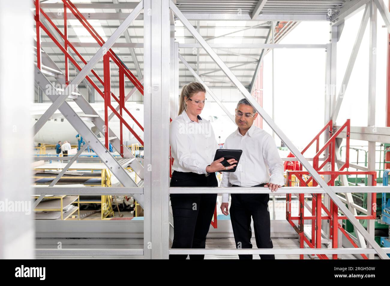 Businesspeople using digital tablet on staircase Stock Photo