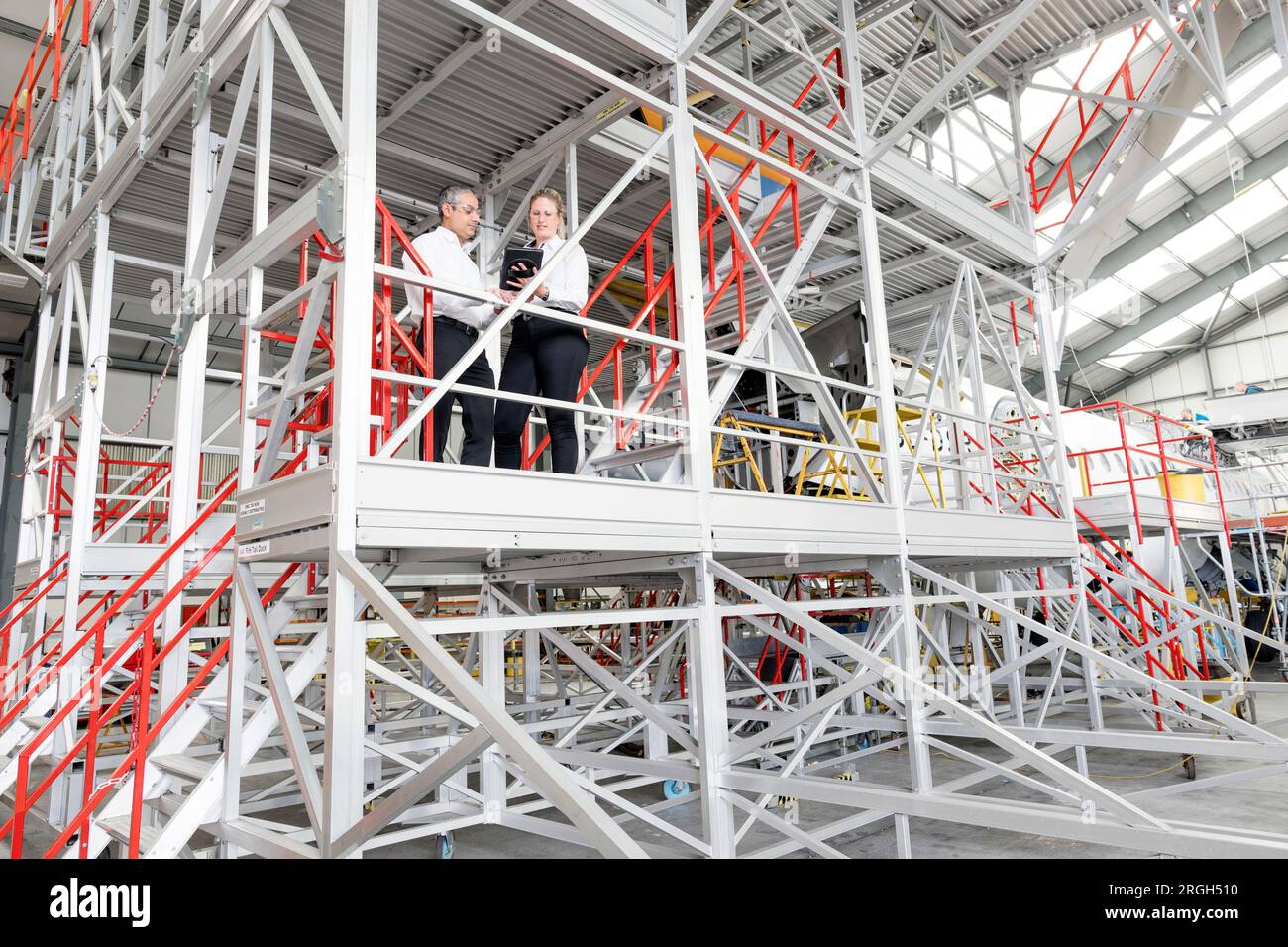 Businesspeople using digital tablet on staircase Stock Photo