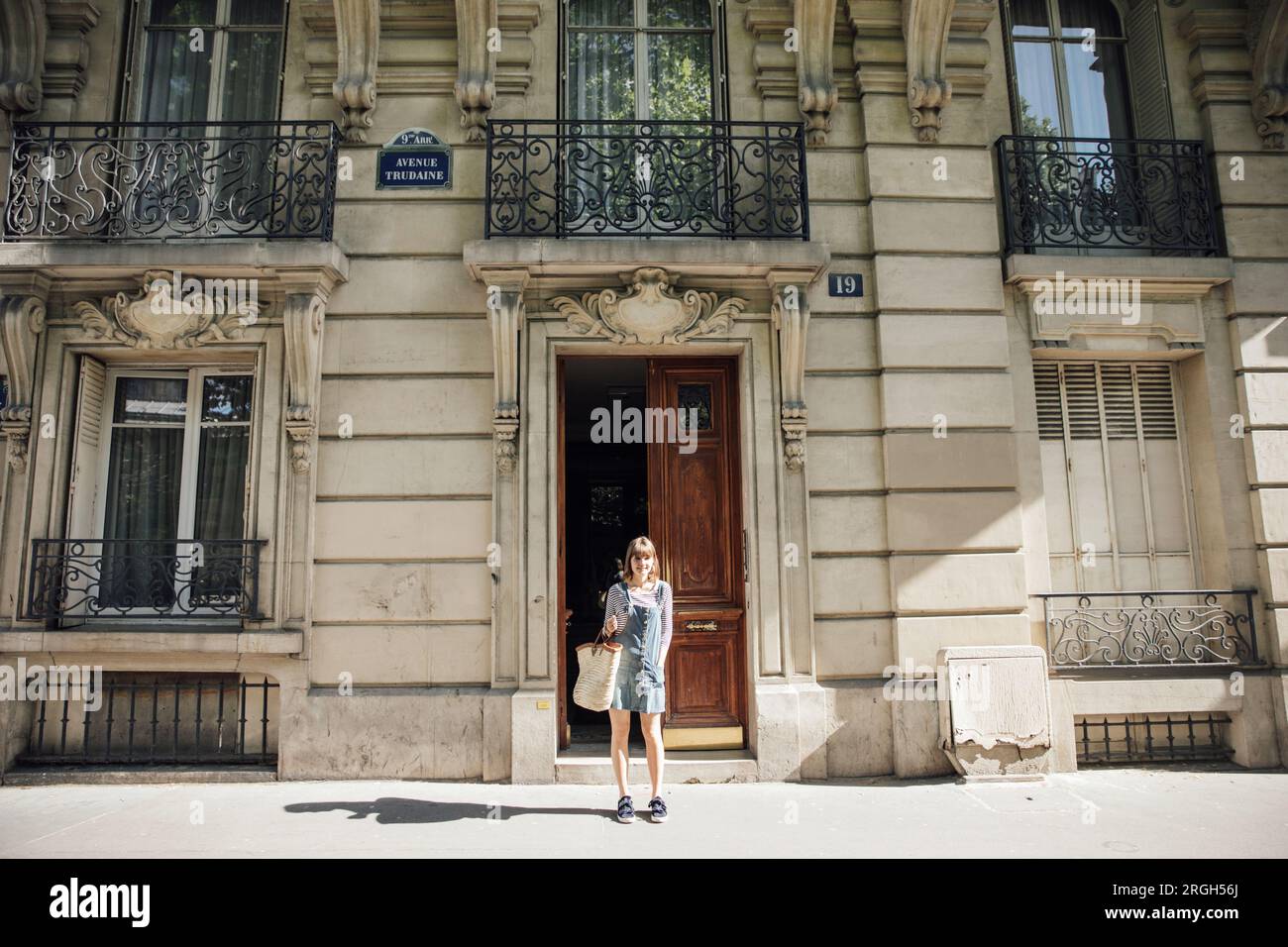 Young woman outside building in Paris, France Stock Photo
