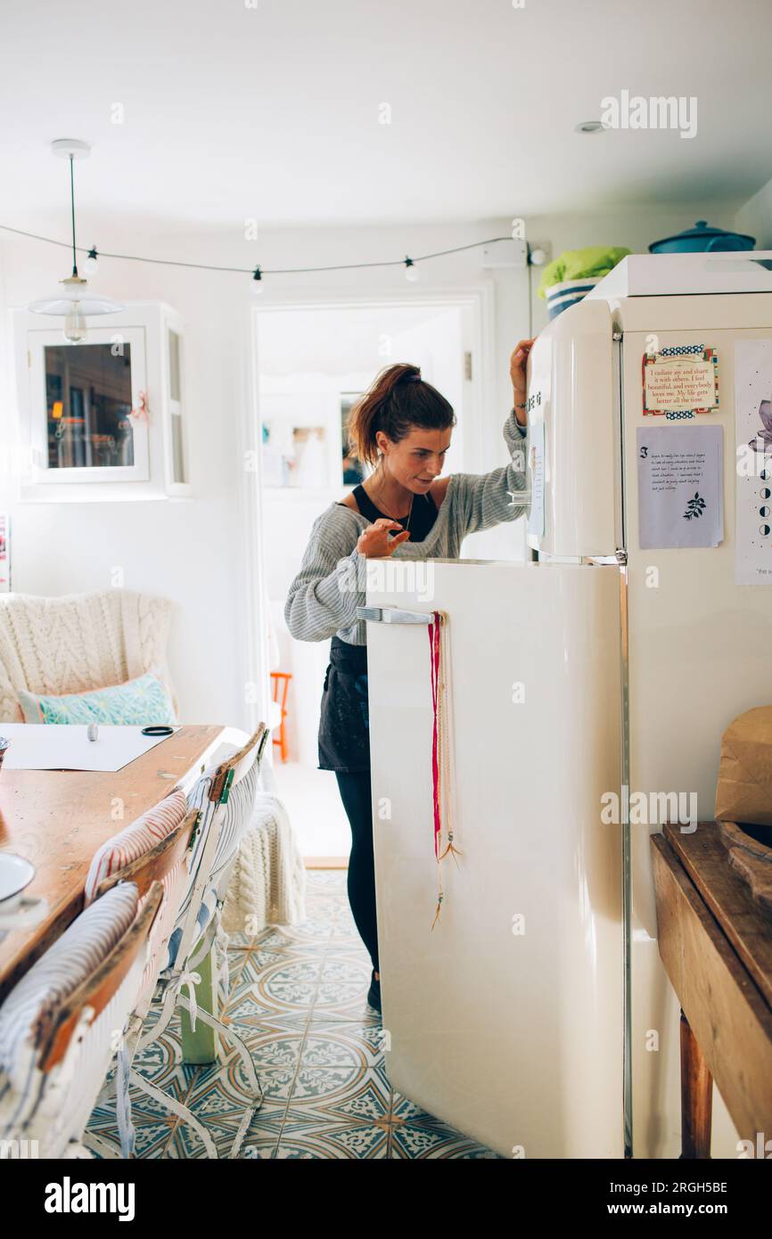 Woman looking into refrigerator Stock Photo Alamy