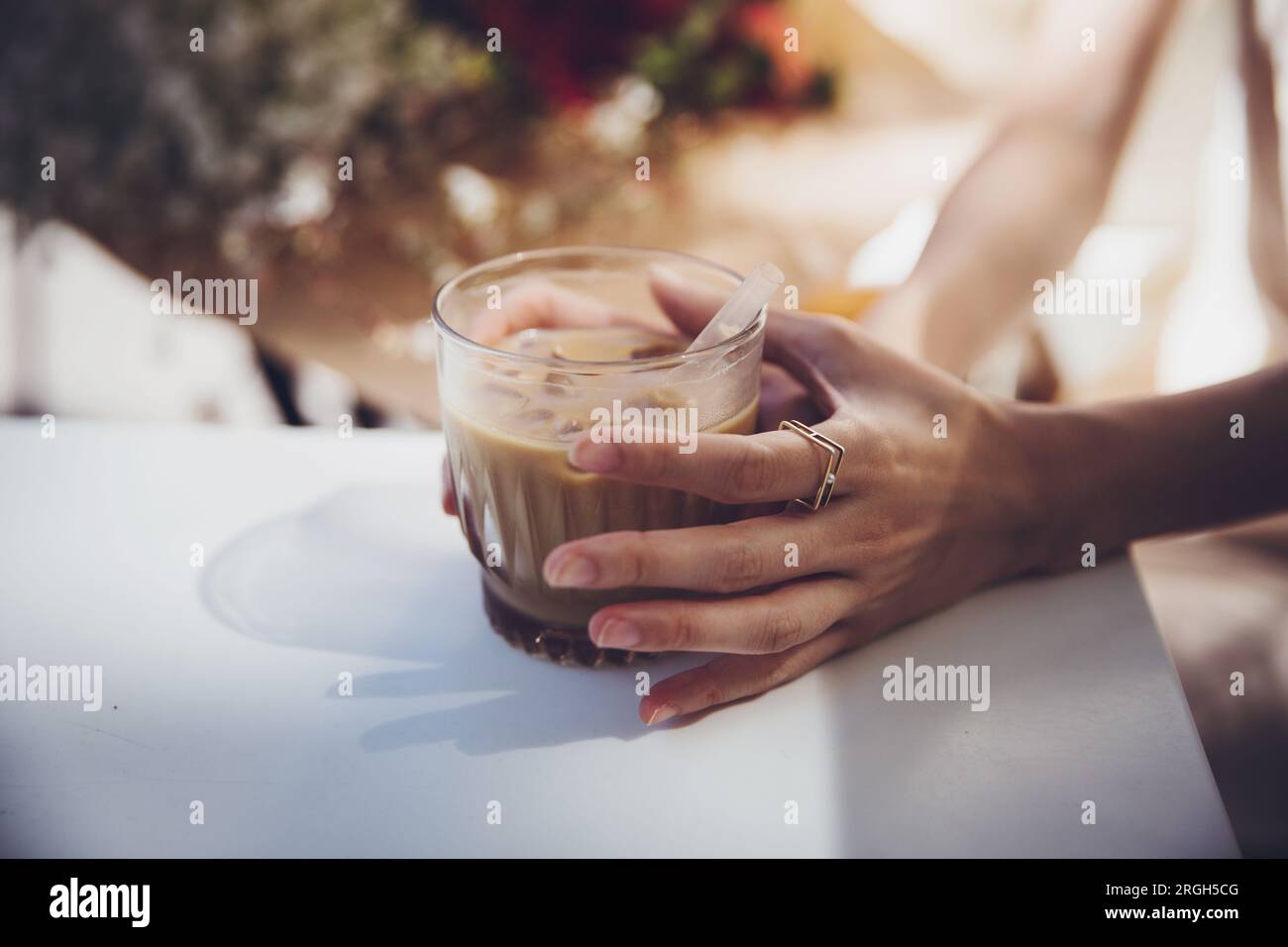 Woman's hands holding iced coffee Stock Photo