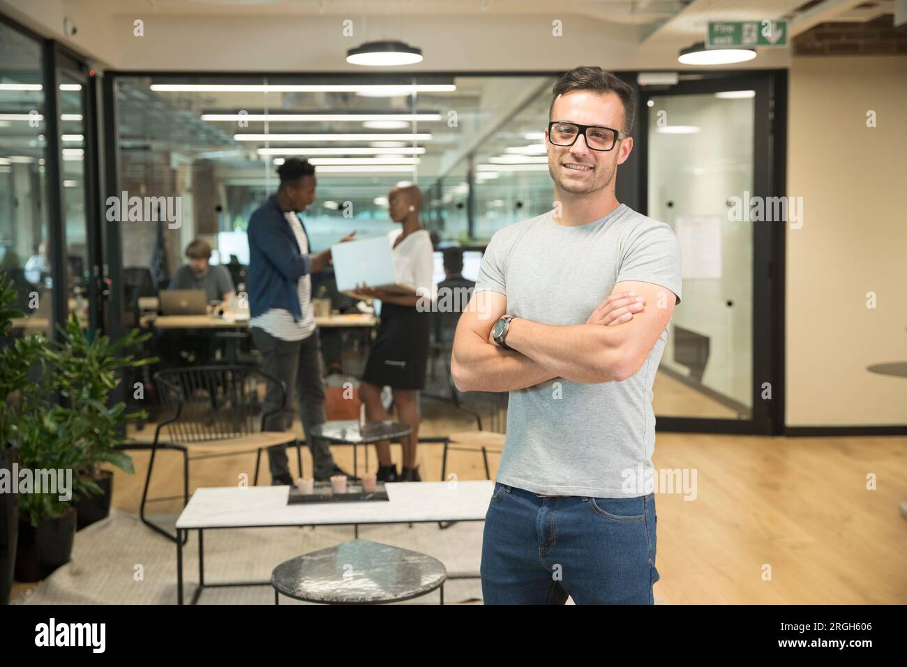Smiling young businessman in office Stock Photo