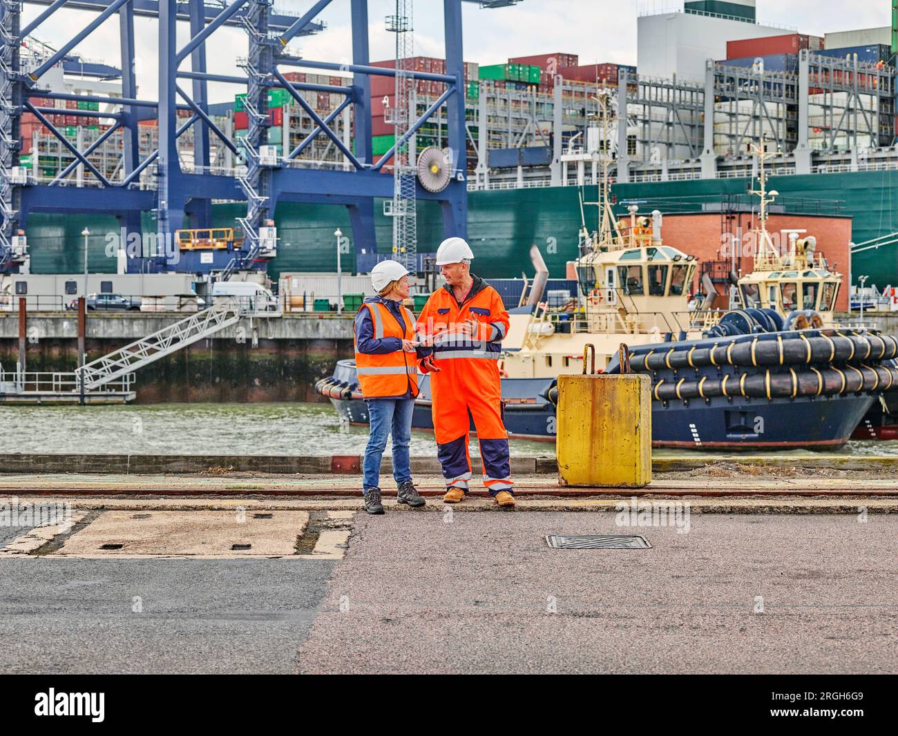 Dock workers with digital tablet at Port of Felixstowe, England Stock Photo