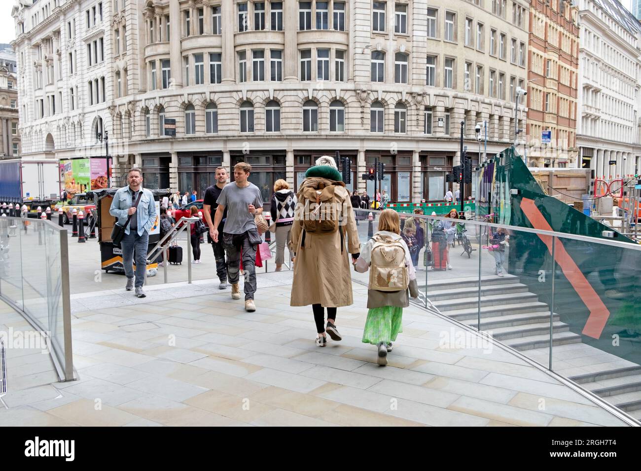 Rear view back mother daughter with backpacks rucksacks and people