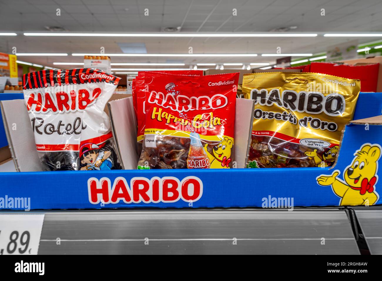 Italy - August 05, 2023: bags of HARIBO sweets on the shelf in an Italian supermarket. Tex: orsetti oro (teddy bears). Gummy Candies Stock Photo