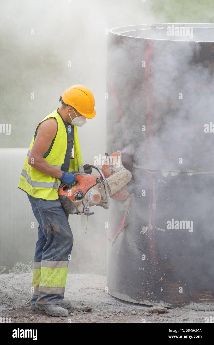 Installing a concrete pipe in the ground to collect rainwater. The