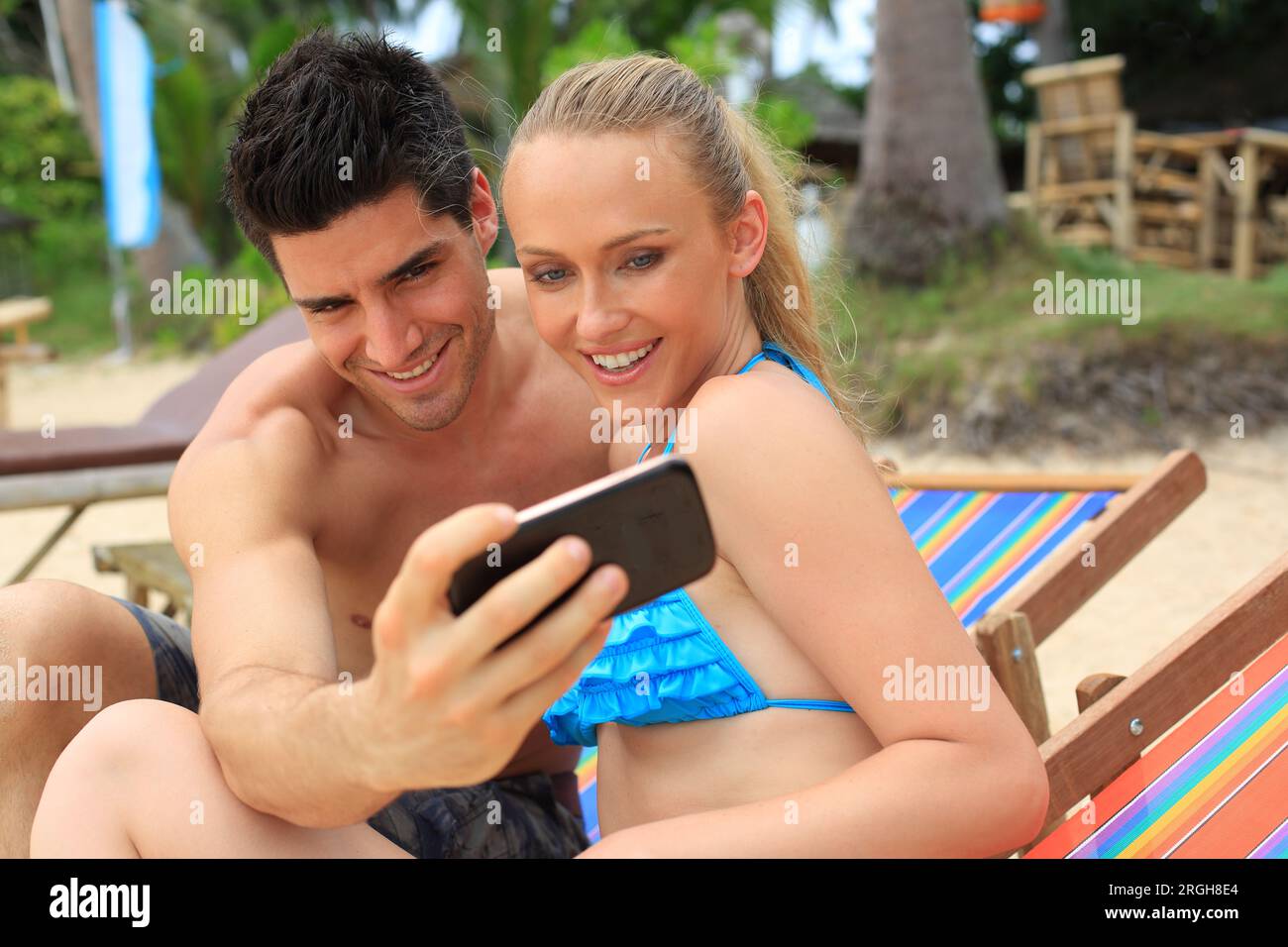 Young couple taking selfie on beach Stock Photo