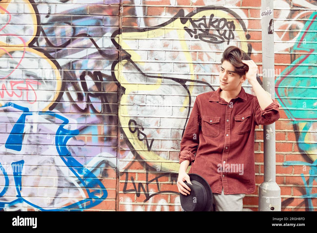 Boy against graffiti wall hi-res stock photography and images - Alamy