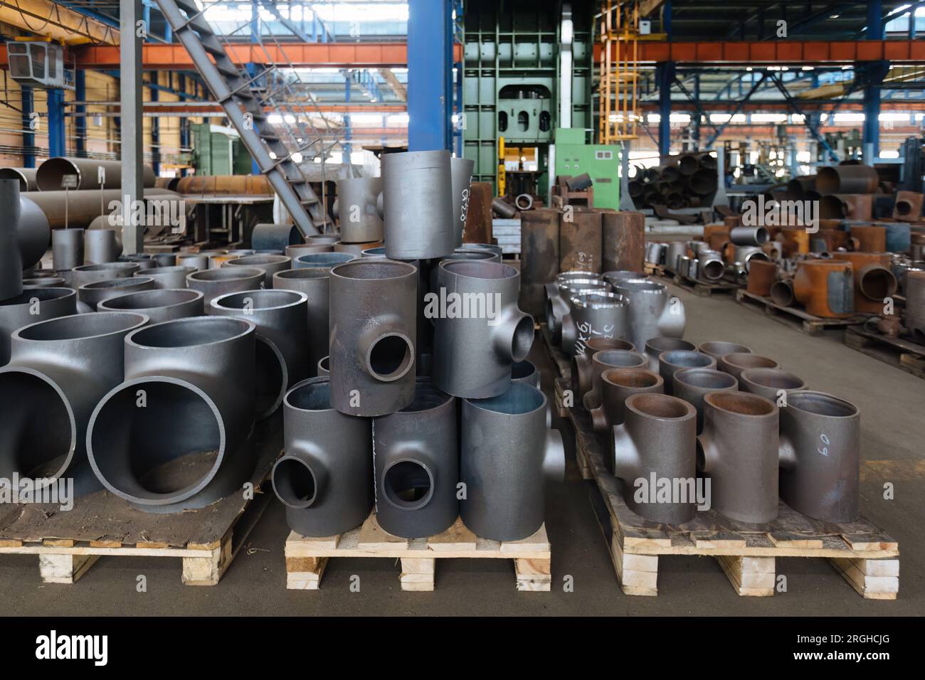 Batch of T shape pipe parts in factory Stock Photo - Alamy