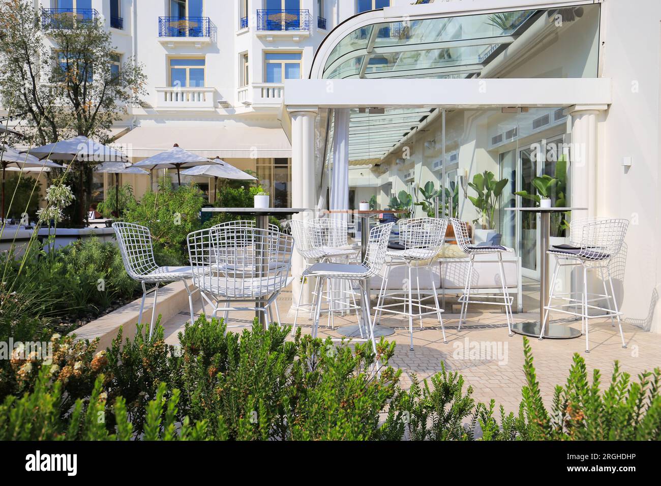 Outdoor summer cafe with white chairs in Cannes Stock Photo