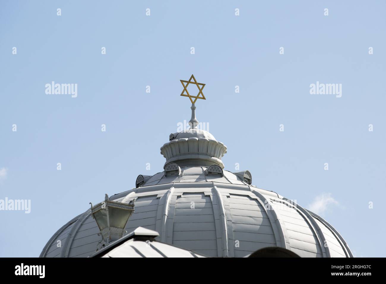 The dome of the synagogue with the star of David on a blue sky background Stock Photo