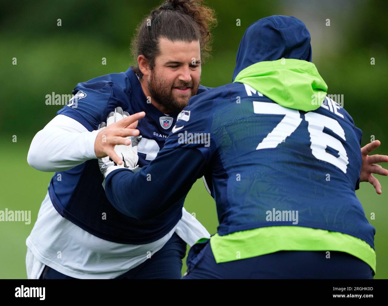 Seattle Seahawks center Joey Hunt (62) and offensive tackle Jalen McKenzie  (76) run a drill during the NFL football team's training camp, Wednesday,  Aug. 9, 2023, in Renton, Wash. (AP Photo/Lindsey Wasson