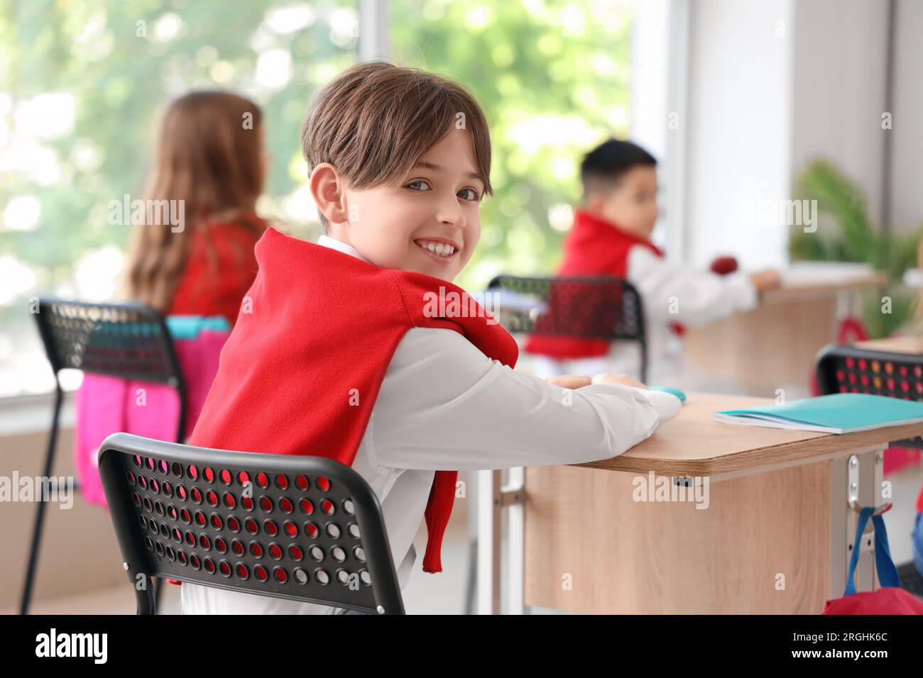 Little schoolboy sitting in classroom Stock Photo Alamy