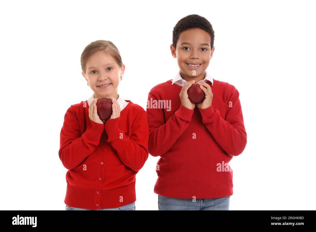 Little students with apples on white background Stock Photo