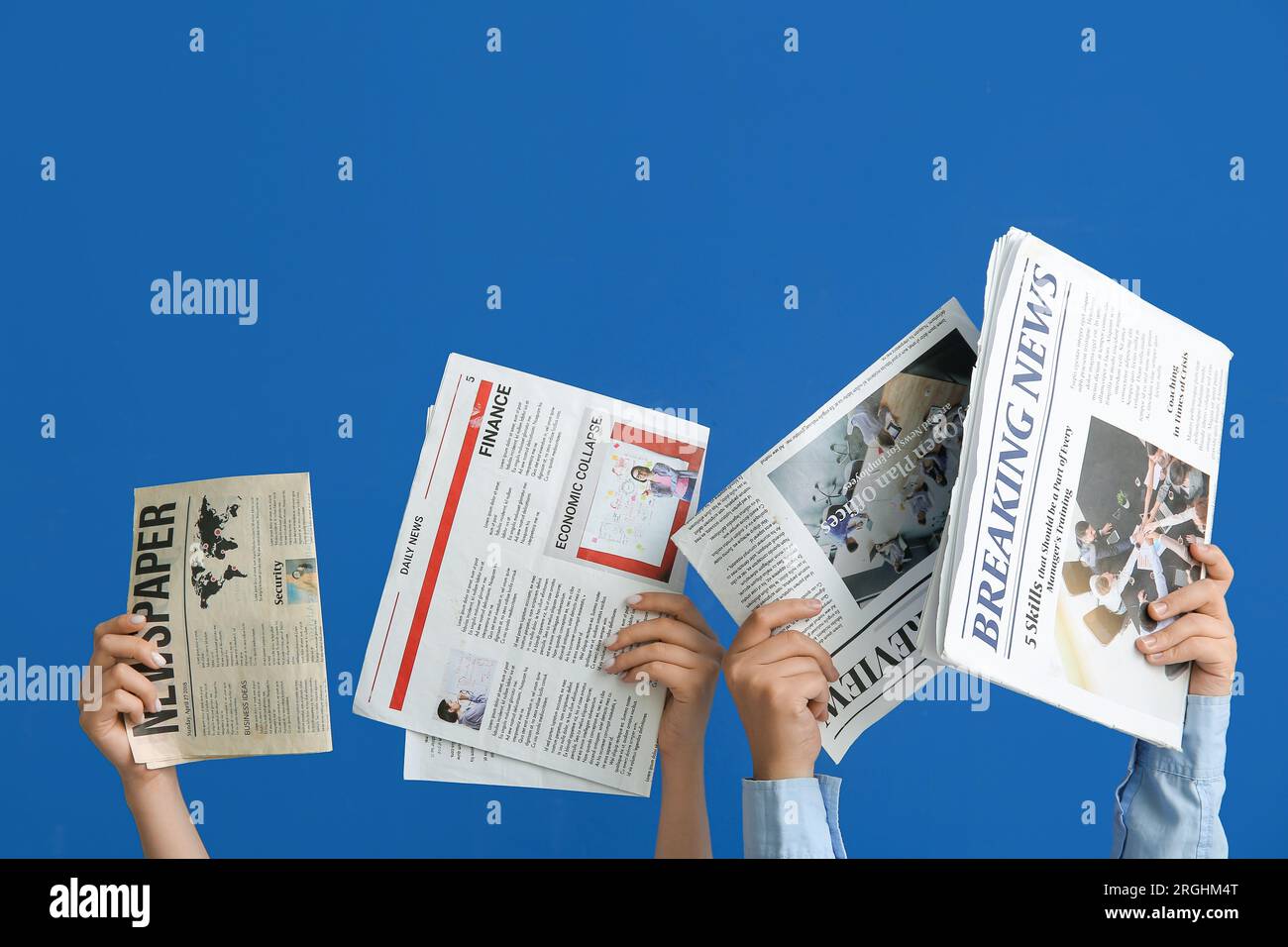 Female hands with different newspapers on blue background Stock Photo