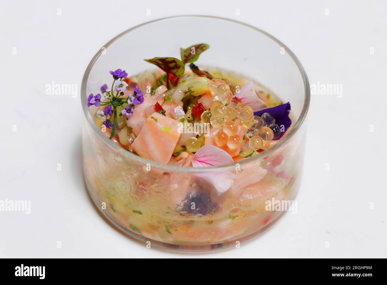 salmon ceviche in a glass dish with white background Stock Photo