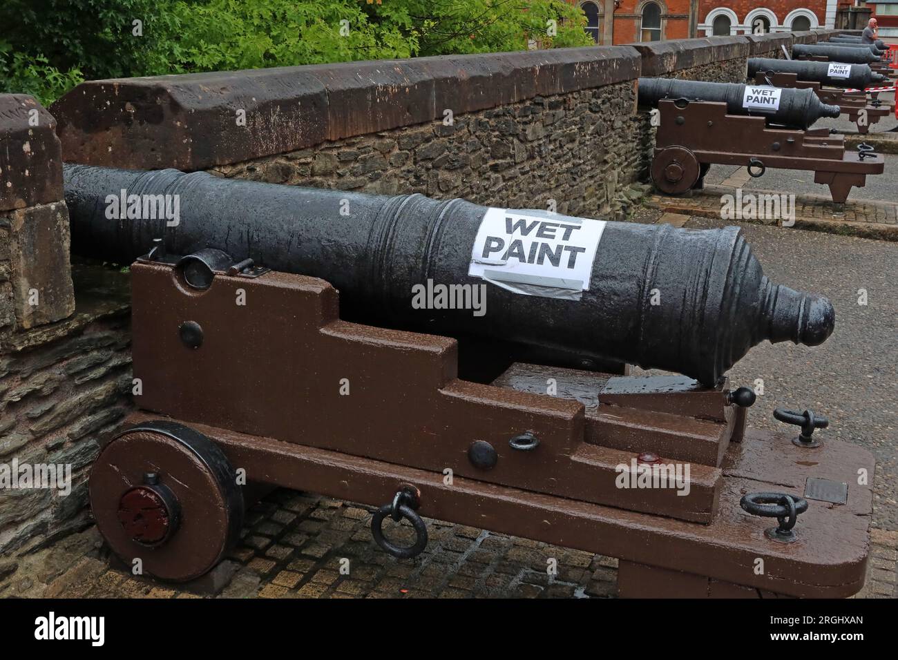Wet paint, repainting historic Cannons on the Londonderry walls, pointing out from the city, County Derry, Northern Ireland, UK, BT48 6PJ Stock Photo