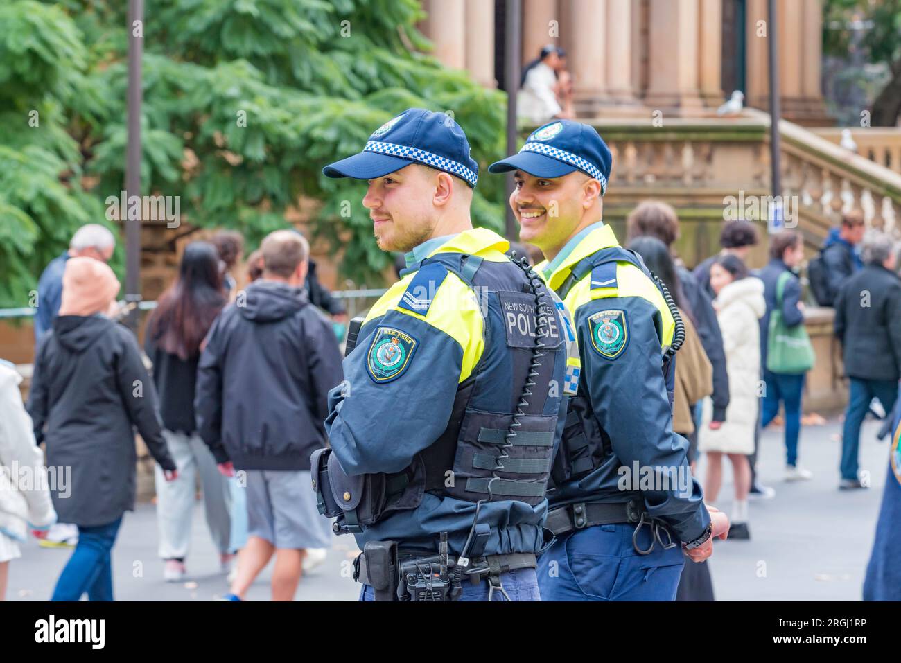 Sydney Aust 06 Aug, 2023: Two happy smiling NSW police officers attending the Sydney Town Hall for the annual Hiroshima and Nagasaki Rally in Sydney Stock Photo