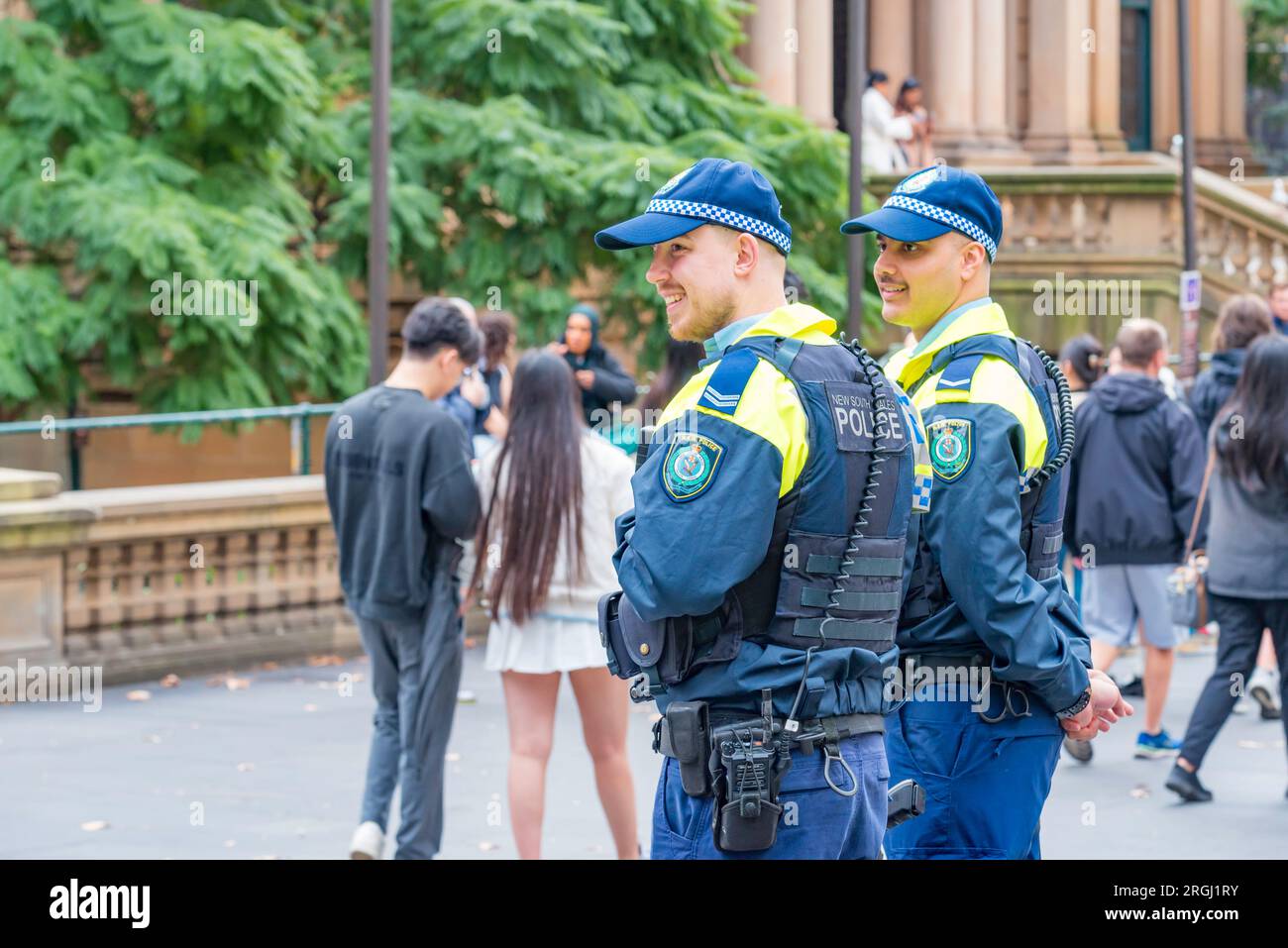 Sydney Aust 06 Aug, 2023: Two happy smiling NSW police officers attending the Sydney Town Hall for the annual Hiroshima and Nagasaki Rally in Sydney Stock Photo