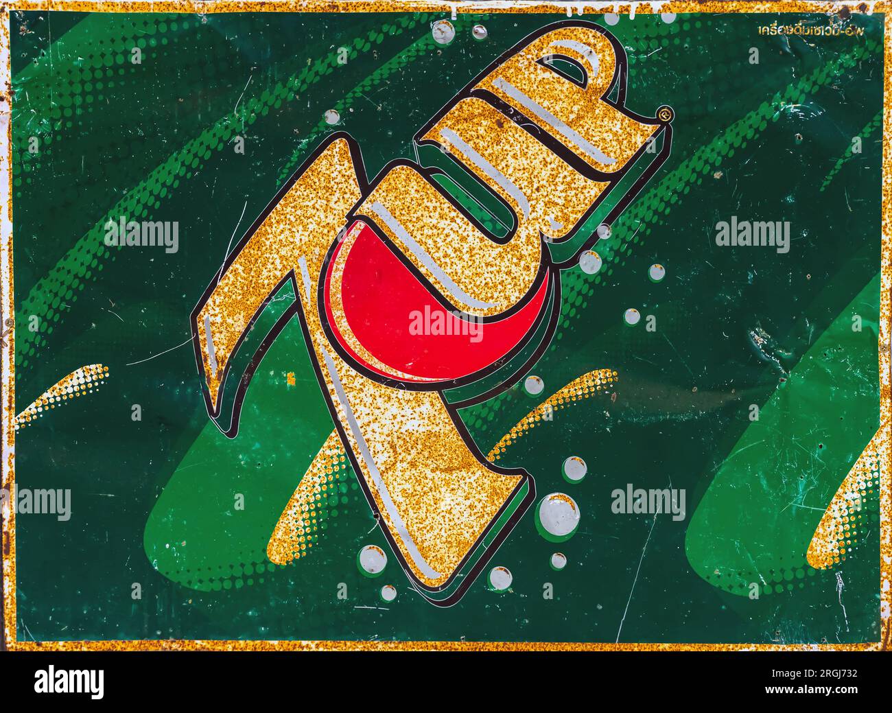 KANCHANABURI, THAILAND-JUNE 28,2023 : Close up vintage 7 UP logo banner, old rusty and broken zinc plate of 7 UP soft drink sign board advertising to Stock Photo