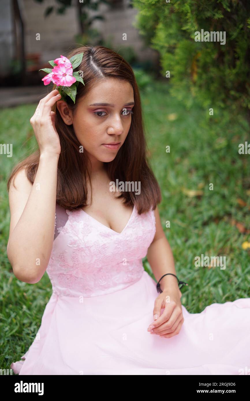 Beautiful latin hispanic girl in a pink dress for quinceanera