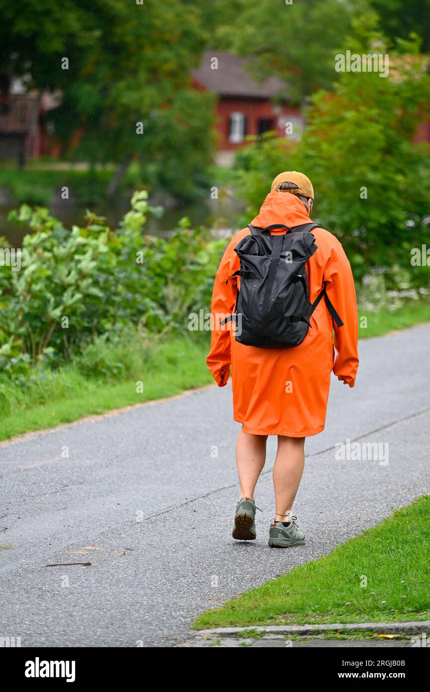 Person in orange coat hi-res stock photography and images - Alamy