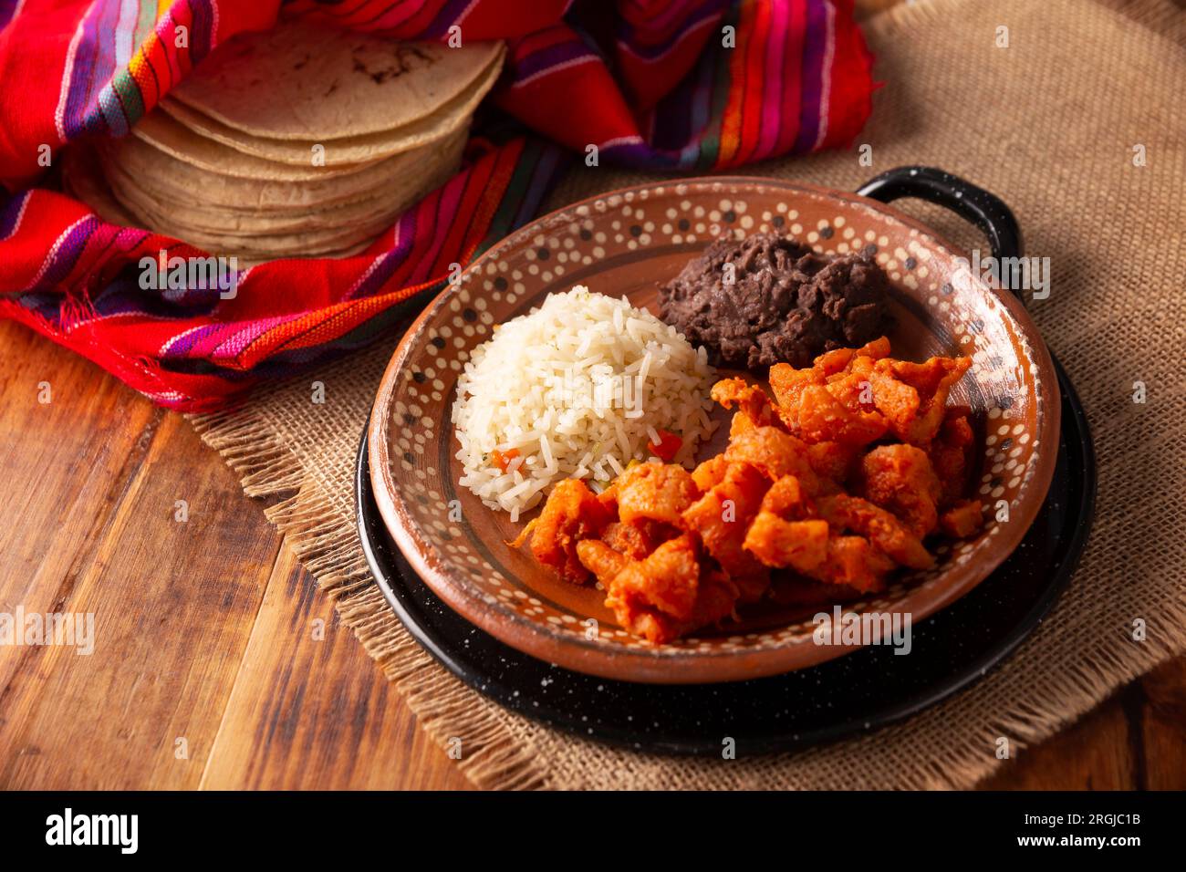 Chicharron en salsa roja. Pork rinds stewed in red sauce by
