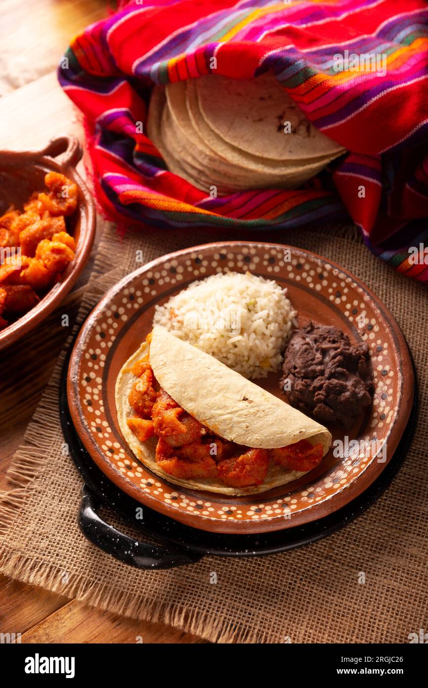 Chicharron en salsa roja. Pork rinds stewed in red sauce by