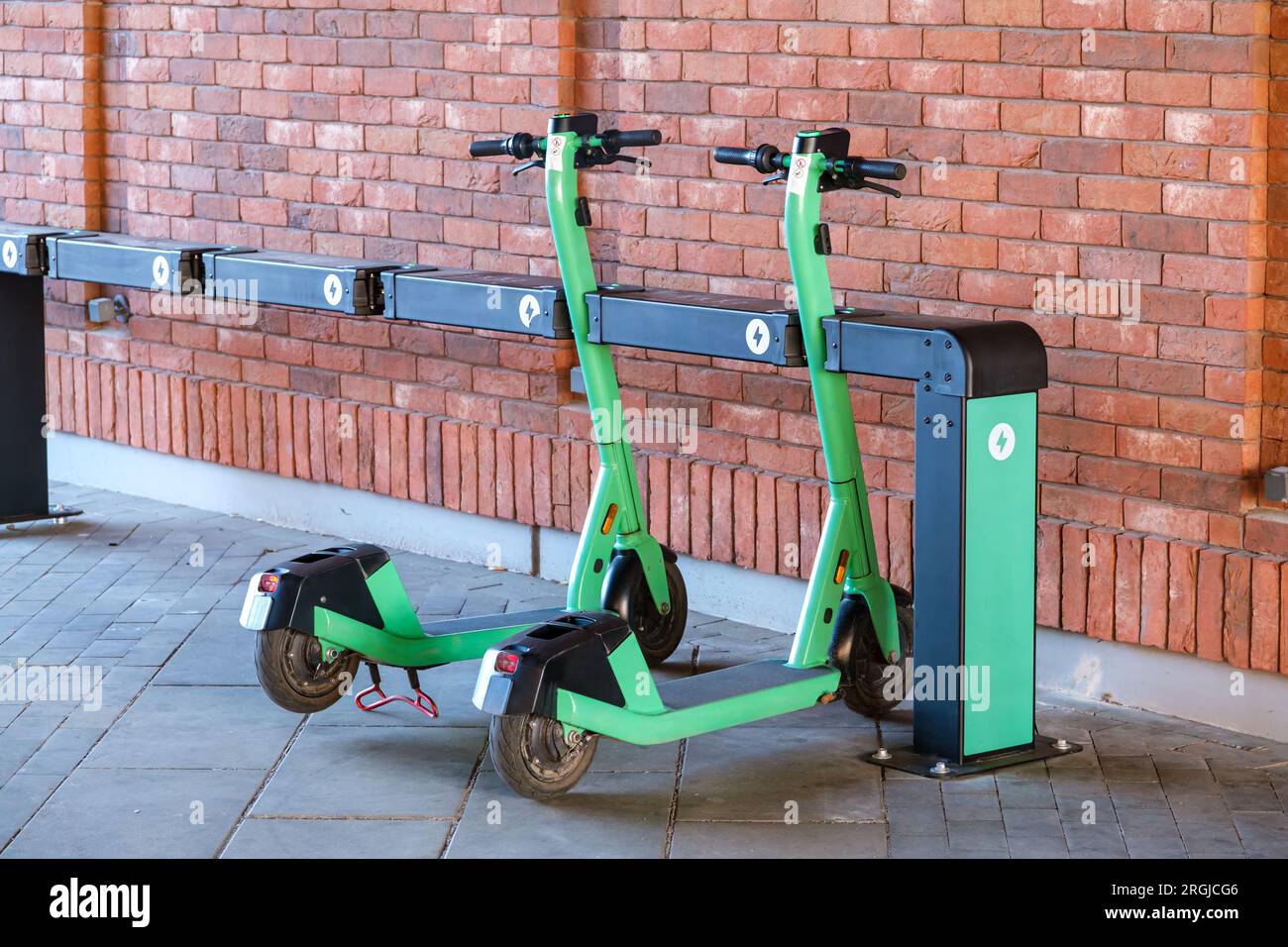 A parked electric scooter rental stand on a city street. Scooters on