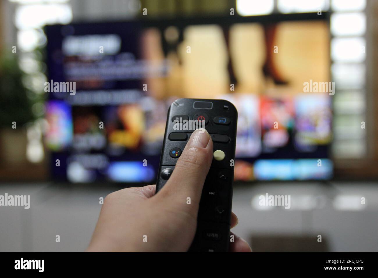 Cord Cutters Watching tv and using remote control Stock Photo - Alamy