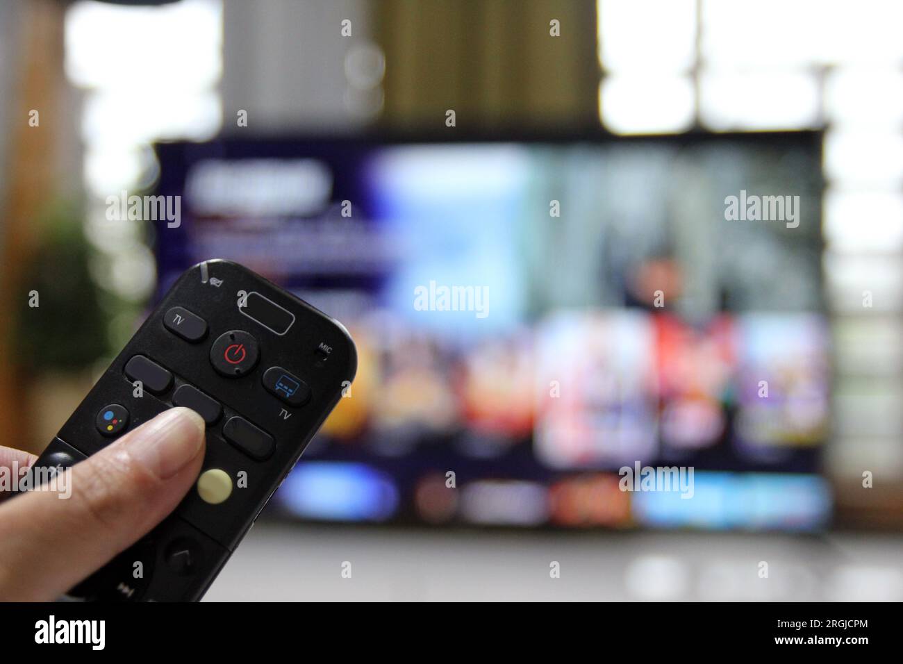 Cord Cutters Watching tv and using remote control Stock Photo