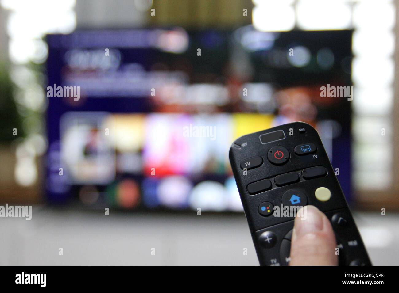 Cord Cutters Watching tv and using remote control Stock Photo - Alamy