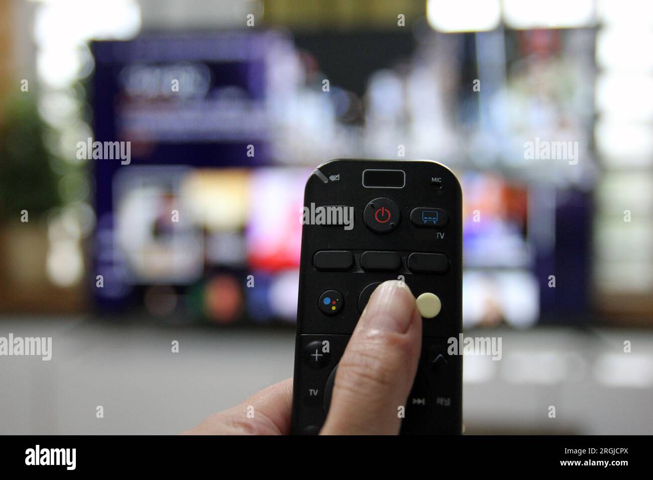 Cord Cutters Watching tv and using remote control Stock Photo - Alamy