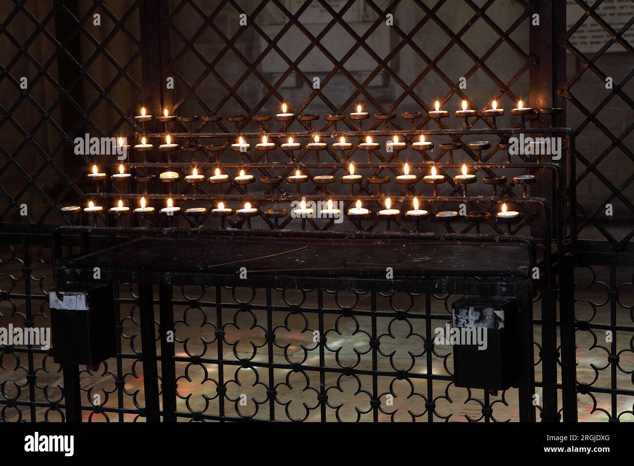 Votive candles in memory of loved ones that have passed on. Stock Photo