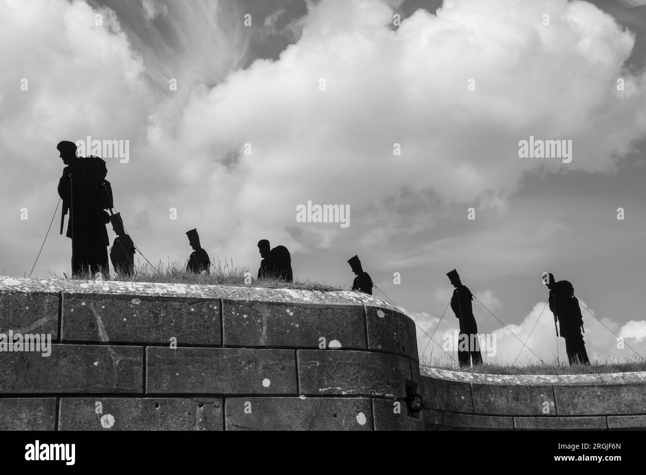 Silhouetted figures at Standing with Giants a tribute to those who lost their lives in the Falklands Conflict Stock Photo