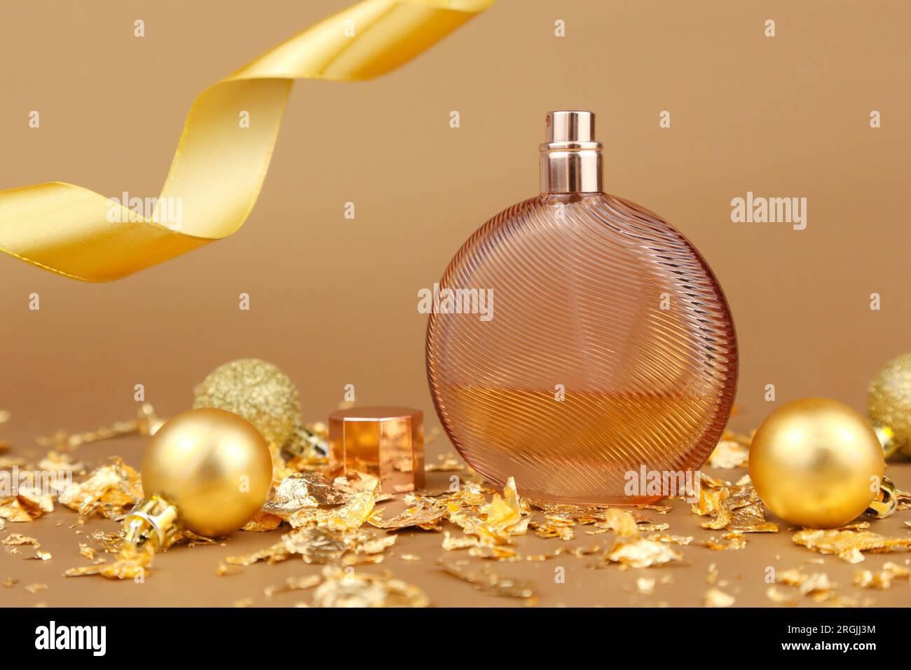round brown perfume bottle, cologne, christmas balls, pieces of gold