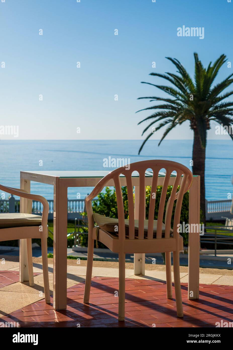Chairs and tables on a seafront terrace in Nerja, Malaga. Stock Photo